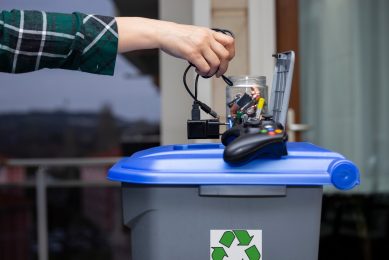 man throwing electro-waste and batteries in the bin